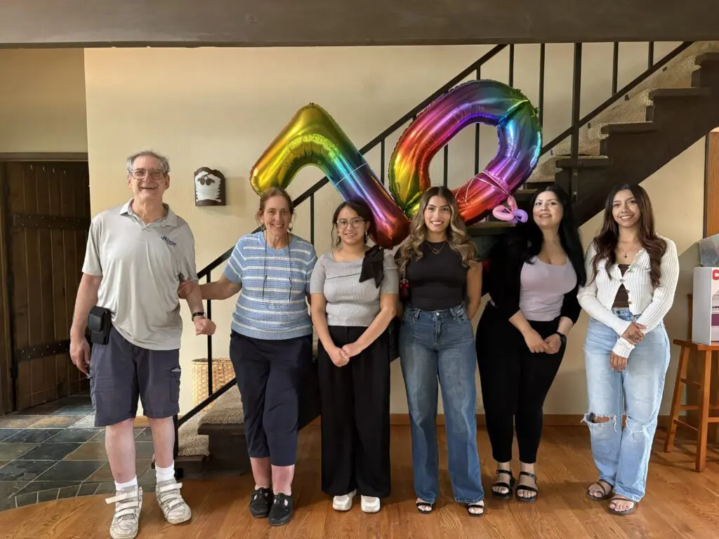 Group of people with rainbow 40 balloons